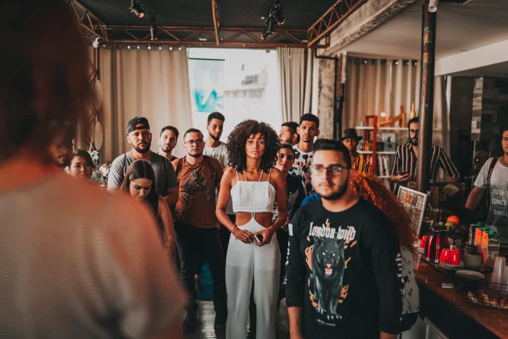 Diverse people listening to speaker in modern studio